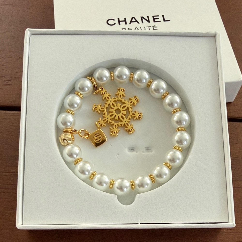 Last one CHANEL GWP Gold and White Pearl Snowflake Charm Bracelet
